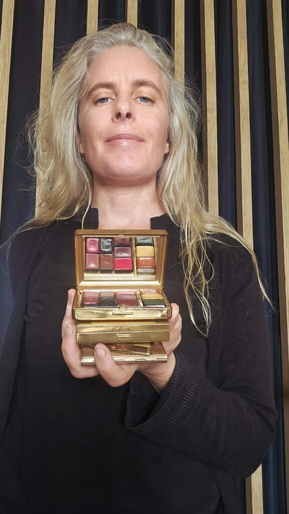Constance, créatrice de Madame Pigmentum, tenant une boîte ancienne transformée en palette d'aquarelle